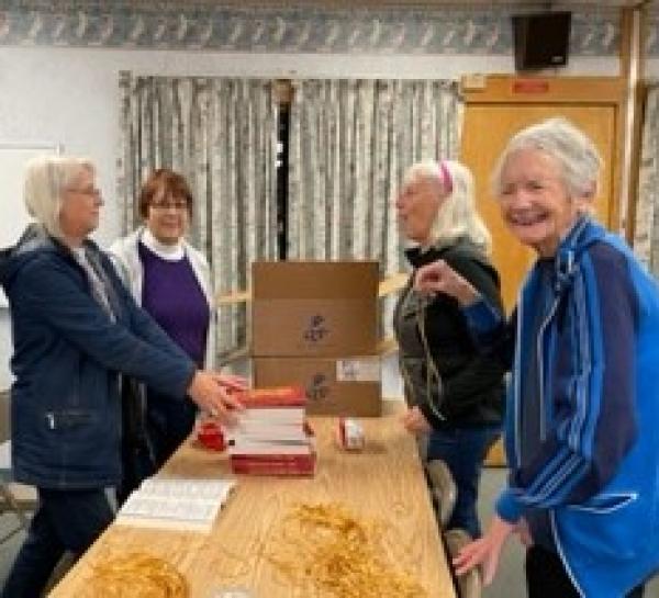 Past Regent Annette Gann, and Catholic Daughters Darlene Rogers, Nicole Duhamel, and Nan Perron put ribbons in the new missals during Make A Difference Day. 
